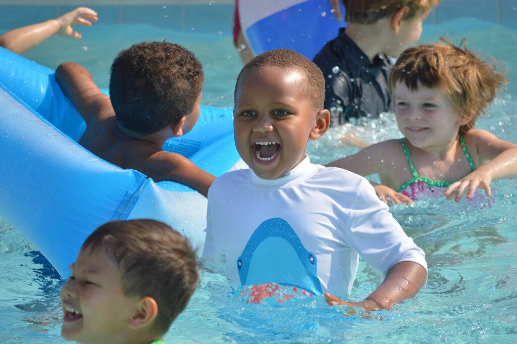 Cooling down and having fun in the pool during summer camp!