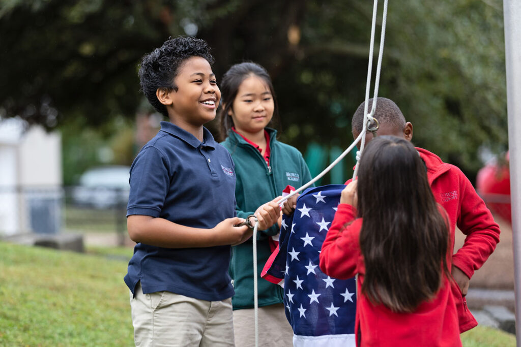 3rd grade students raising the flag