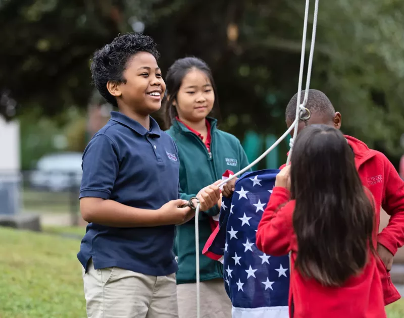 3rd grade students raising the flag