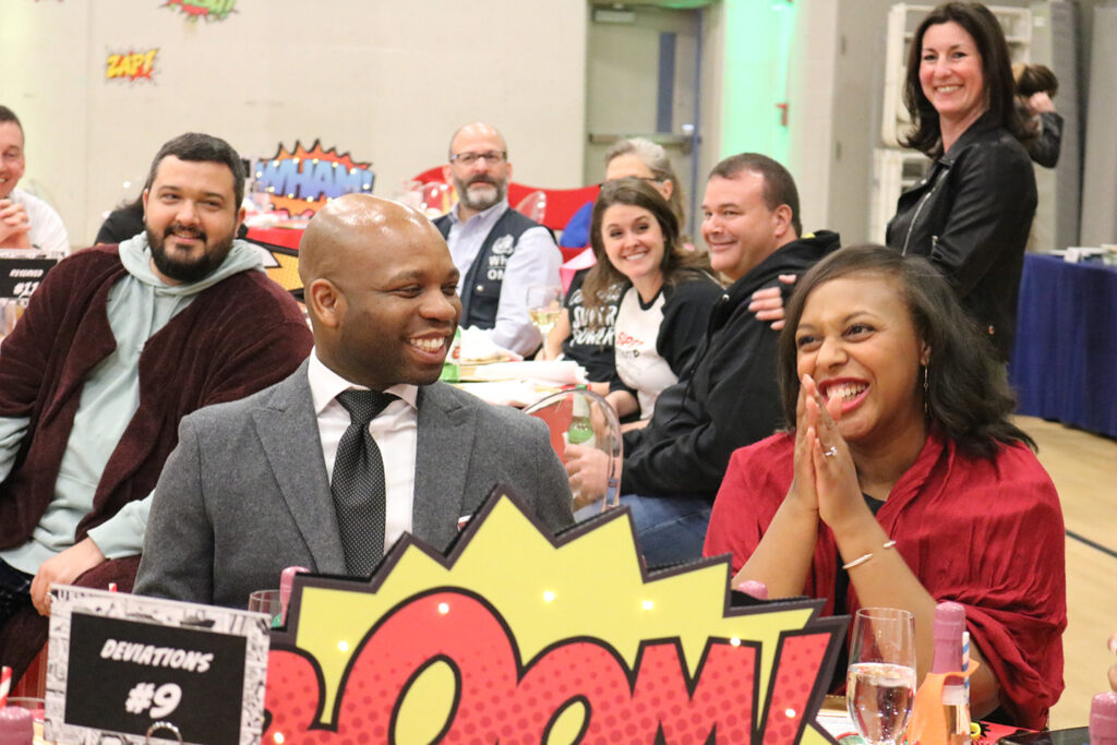 people smiling at tables during the annual benefit