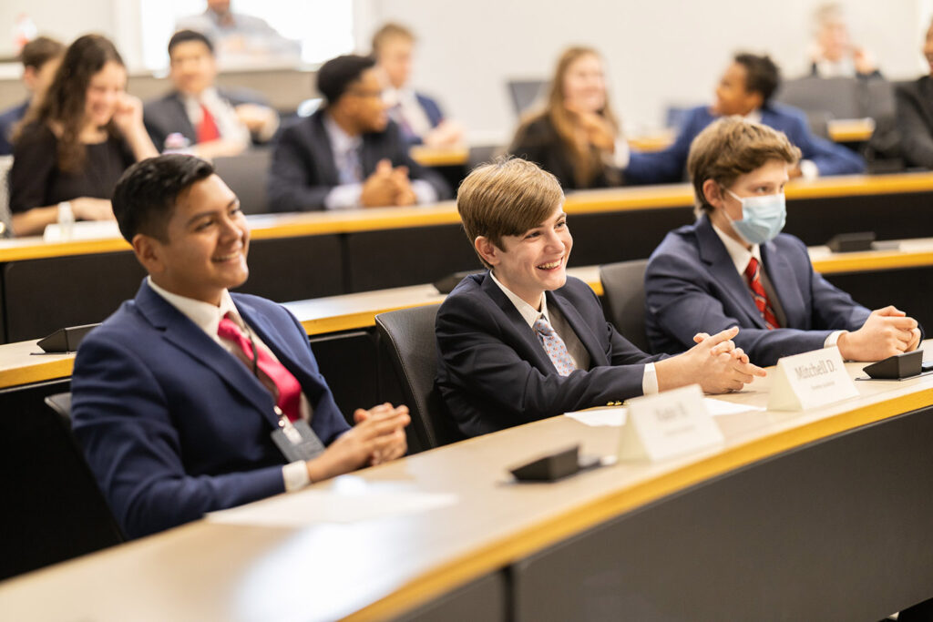 students sitting at table during their We the People presentation